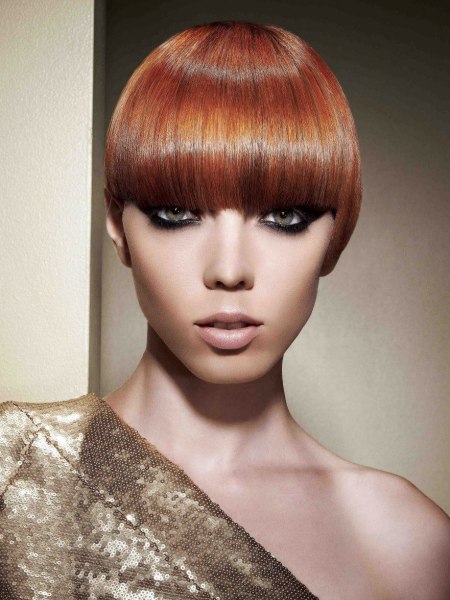 Very short hairstyle with a glossy blunt fringe that covers the eyebrows