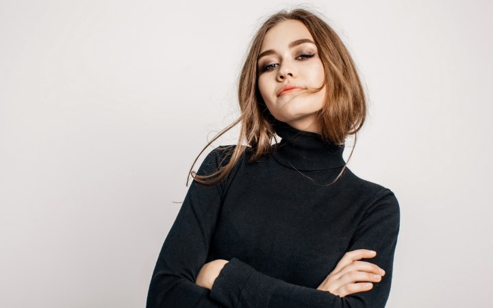 Woman who is wearing a stylish black turtleneck