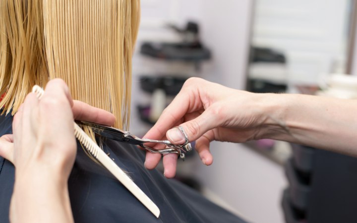 Hairdresser cutting an angled bob