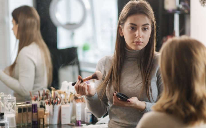 Beautician who is doing make-up