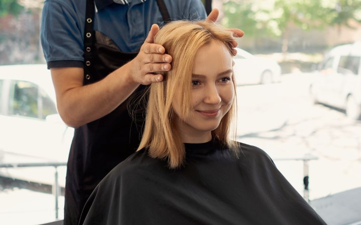 Caped girl and hairdresser