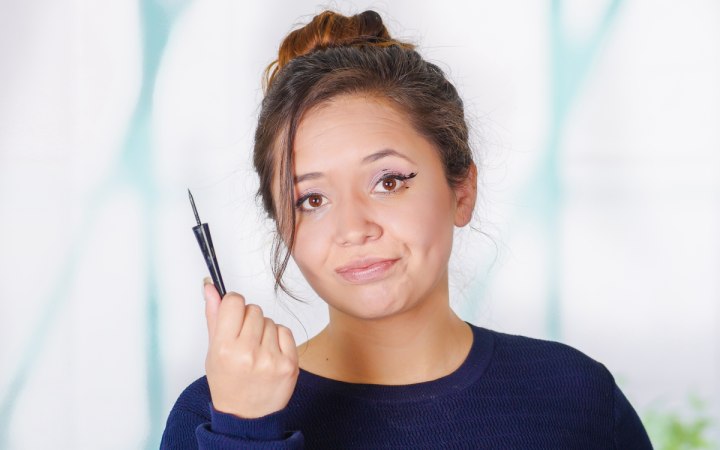 Woman who has a problem with her eyeliner