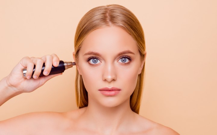 Woman who is removing hair from her ears