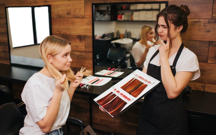 Girl who is choosing a new hair color in a salon