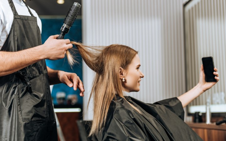 Client in  a hair salon taking a selfie